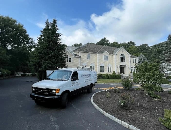 Westlake Power Washing technician performing thorough gutter cleaning service in Westlake